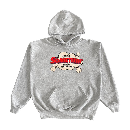 Cookin' Somethin' Original Hoodie featuring a cartoon-style logo design with crossed bones and red text on a heather grey cotton pullover. Front kangaroo pocket and drawstring hood complete this casual, YouTube merch sweatshirt.