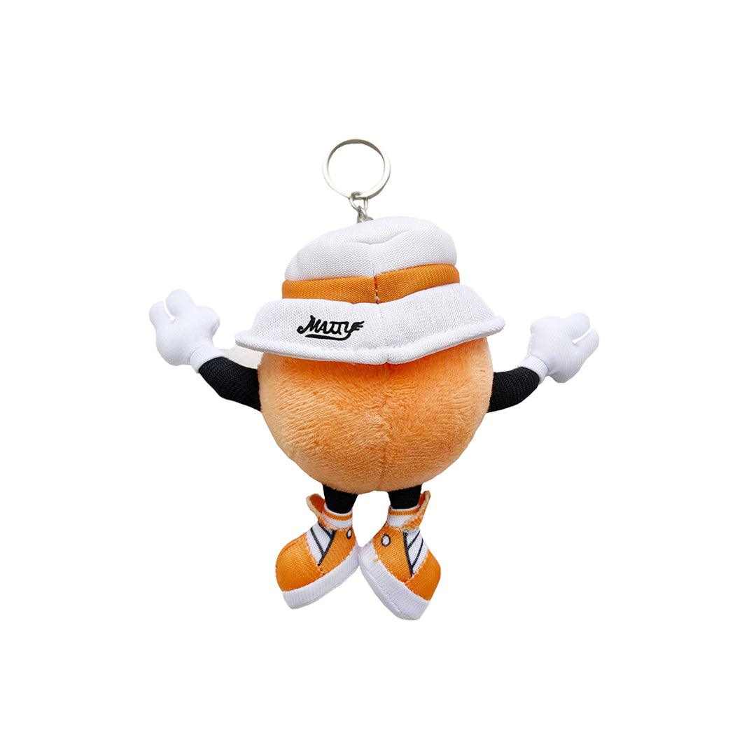 Just A Dash Plush Keychain featuring an orange spherical character wearing a white bucket hat, orange sneakers, and white gloves, with arms raised in a playful pose. The plush has a silver keyring attached for easy carrying.