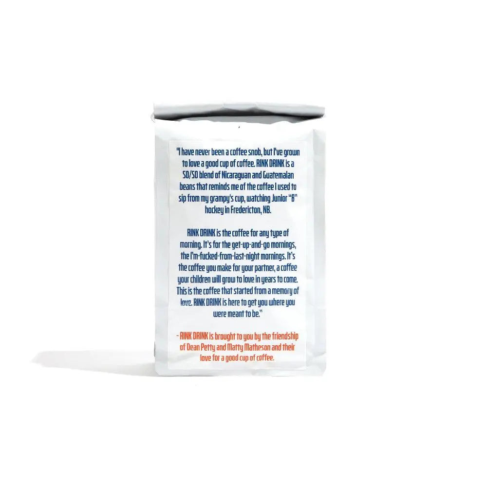 Anchored x Rink Drink Coffee bag displaying product description text in blue and orange against white packaging, featuring a blend of Mexican and Brazilian coffee beans. Simple cylindrical package with nostalgic story about hockey and family memories printed on the front.