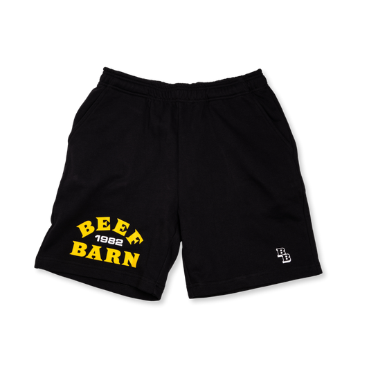 Black shorts with yellow text 'BEEF BARN 1982' on a white background