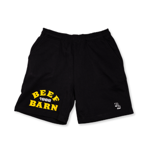Black shorts with yellow text 'BEEF BARN 1982' on a white background