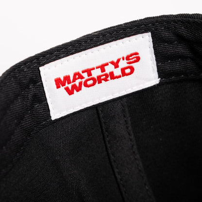Black cap with a 'Matty's World' label on a white background