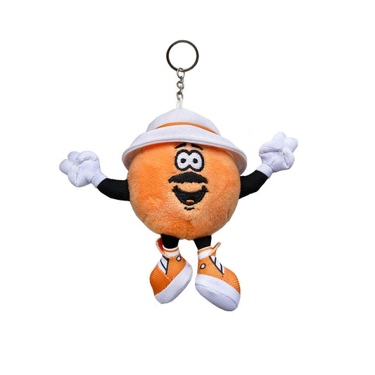 Just A Dash Plush Keychain featuring an adorable orange mascot character with white gloves, white safari hat, and matching white sneakers. The plush has a cheerful expression with large eyes and a friendly smile, attached to a metal keyring.