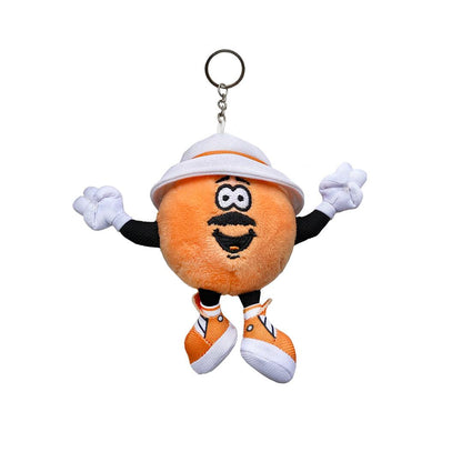 Just A Dash Plush Keychain featuring an adorable orange mascot character with white gloves, white safari hat, and matching white sneakers. The plush has a cheerful expression with large eyes and a friendly smile, attached to a metal keyring.
