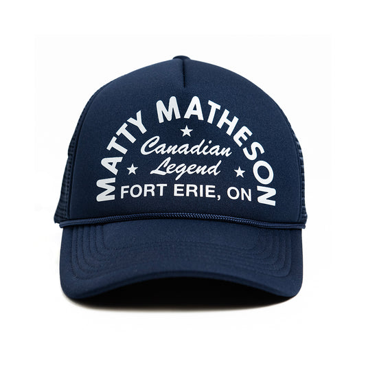 Navy trucker style hat with white text 'Matty Matheson Canadian Legend Fort Erie, ON' printed on the front.