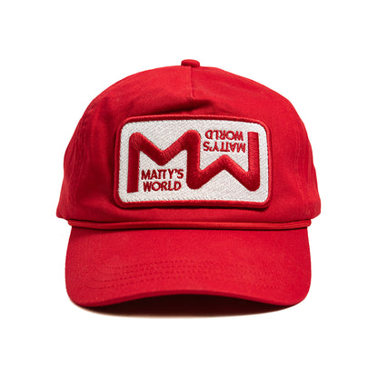 A red 5-panel unstructured hat with an embroidered patch sewn on the front that reads 'Matty's World'.