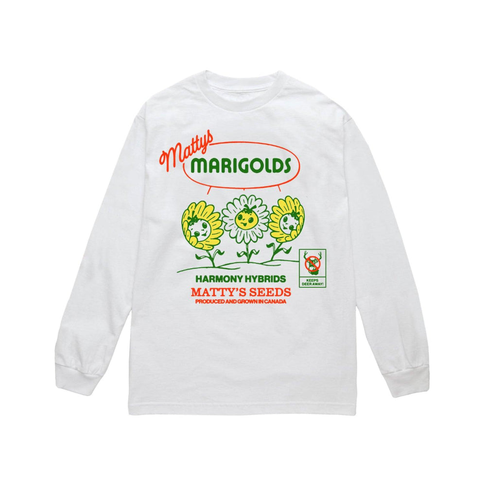 The white cotton long-sleeve shirt from Matty Matheson displays a playful design of three cartoon marigold flowers with smiling faces, accompanied by the text: Mattys Marigolds, Harmony Hybrids, and Mattys Seeds Produced and Grown in Canada. 